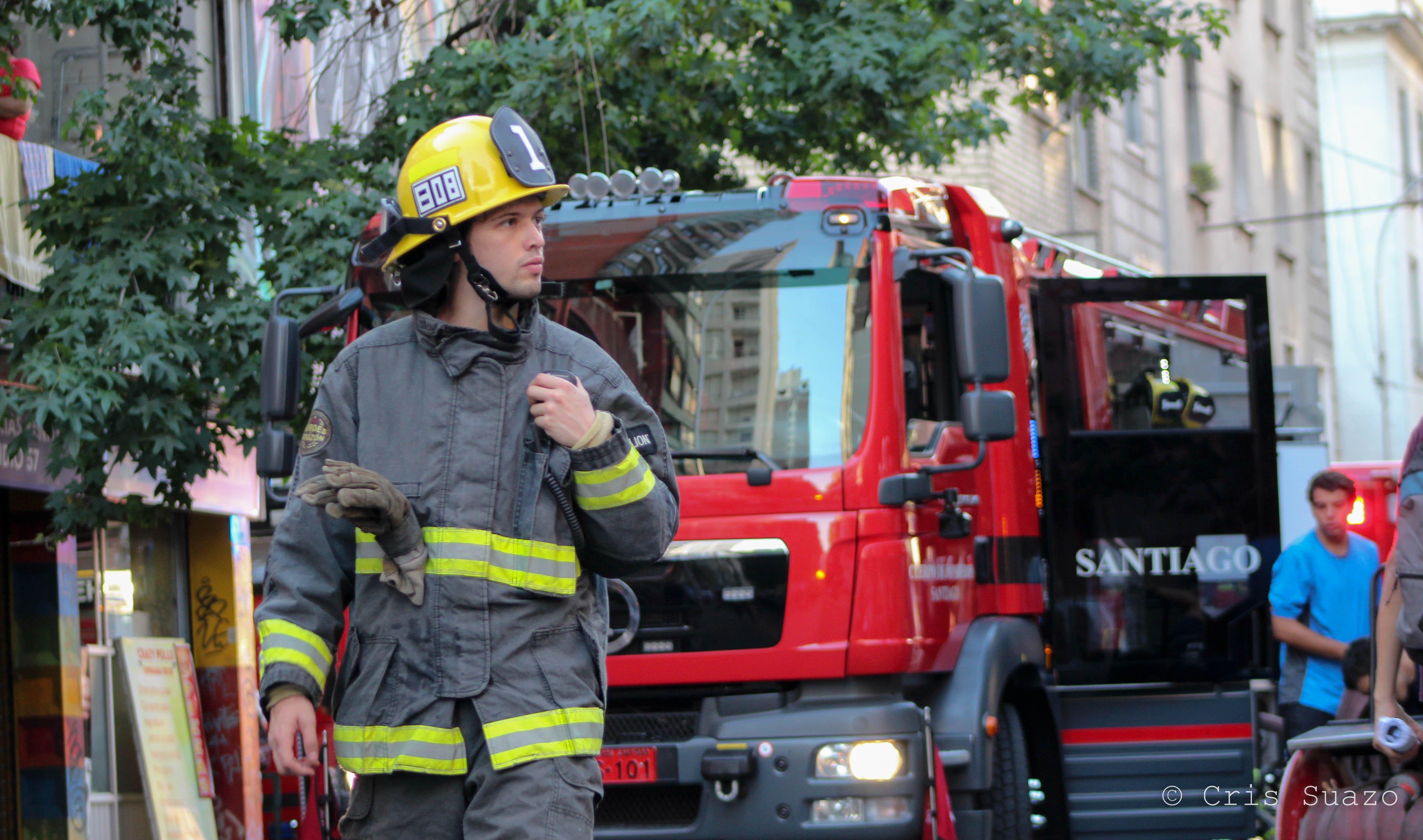 Firefighter walking in front of fire truck in Chile